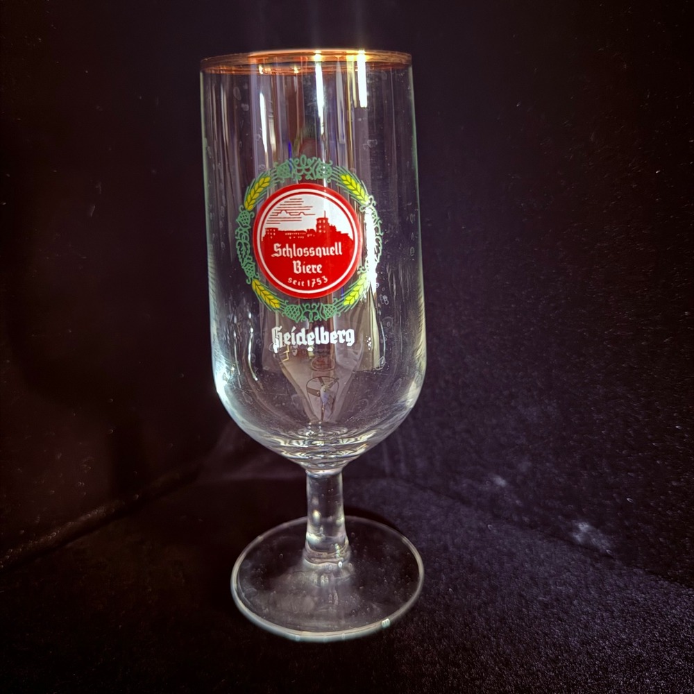 A stemmed beer glass for Schlossquell Biere from Germany with Gold rim.